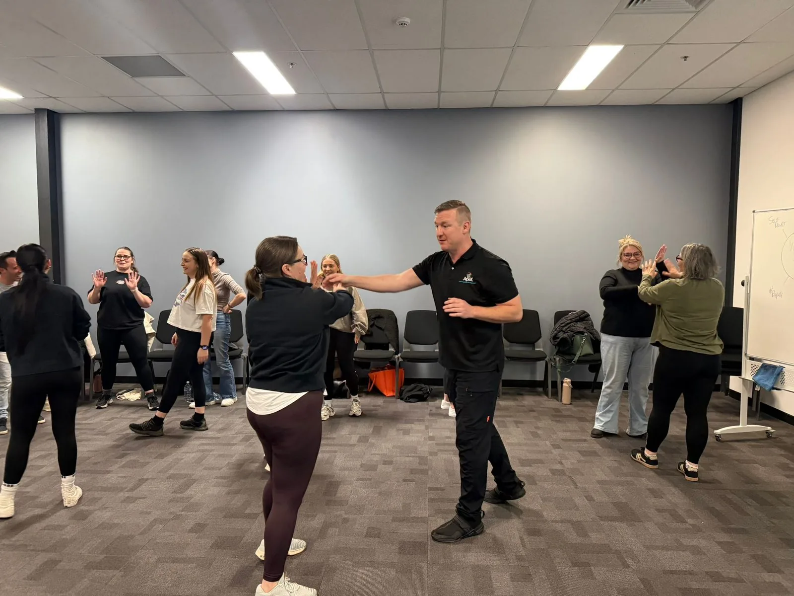 Apex trainer leading a workplace personal-safety demonstration